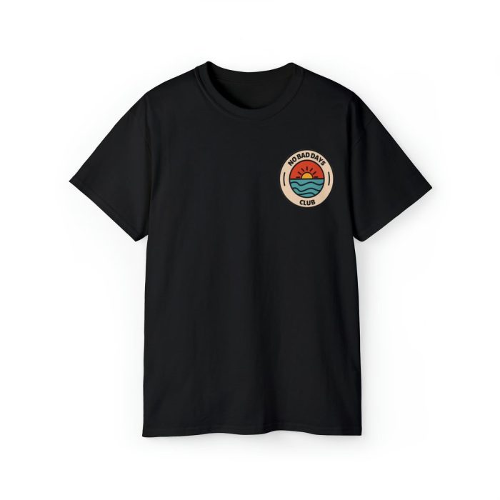 Black T-shirt with 'No Bad Days Club' logo and a colorful sunset over the ocean graphic, displayed on a plain background.